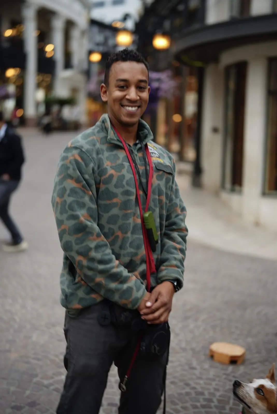 Phillip Flores with a dog in his Gamarada training jacket