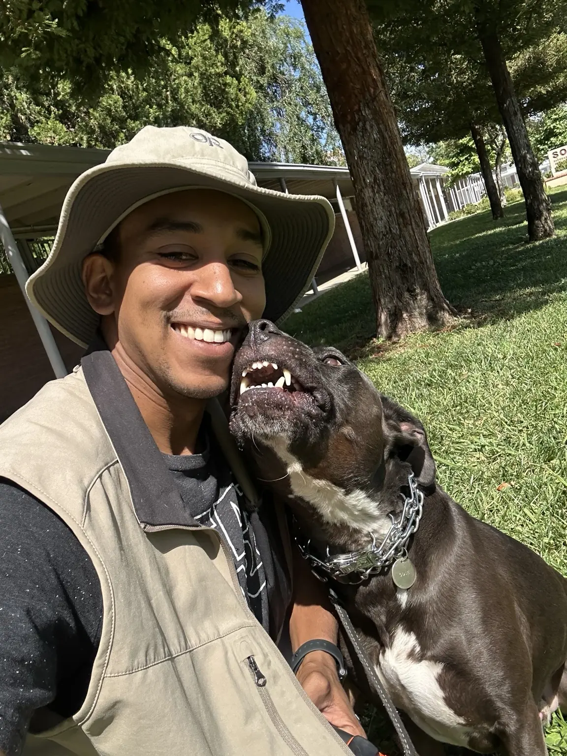 Phillip smiling with a Rottweiler outdoors